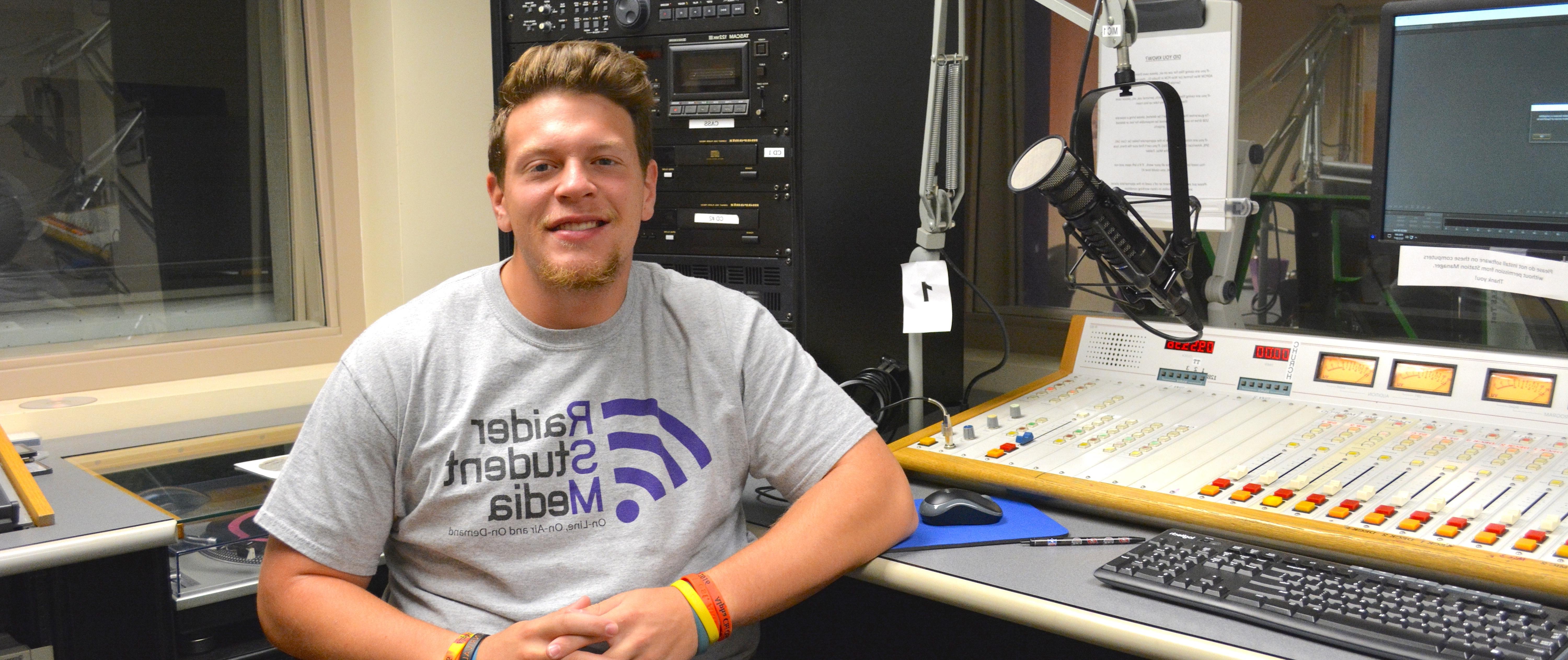 Joe Mertens sitting in a radio station booth 